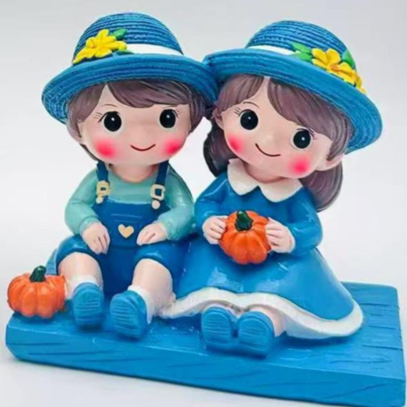 Sitting boy and girl couple figurine blue garden